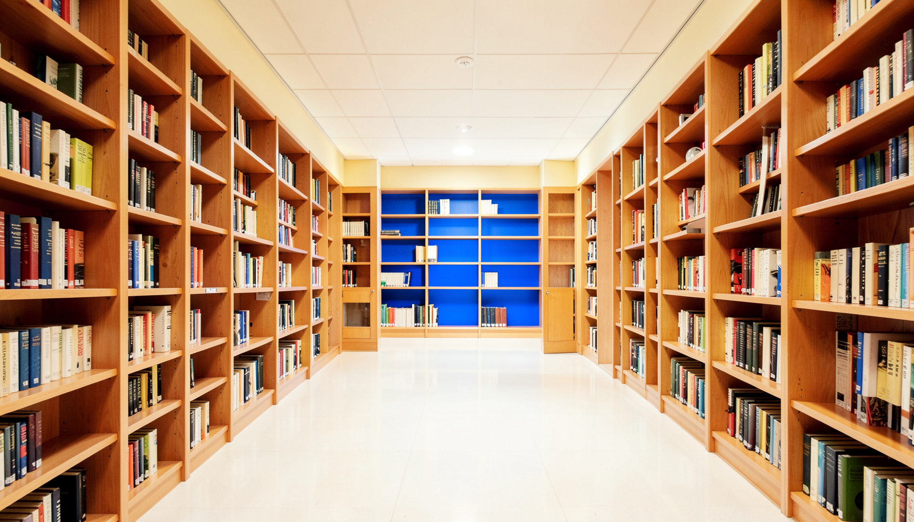 A clean, well-lit medical library interior with tall wooden bookshelves, warm amber and cream tones, strong symmetrical composition.